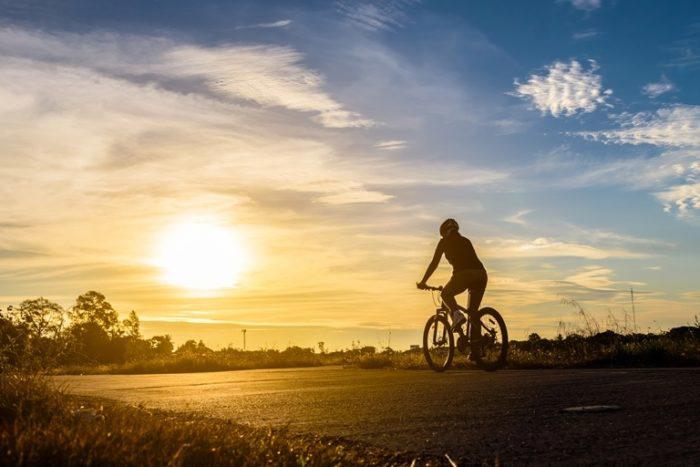Cyclist riding off into the sunset