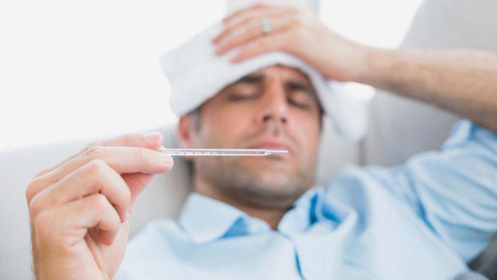 Man holding a temperature themometer