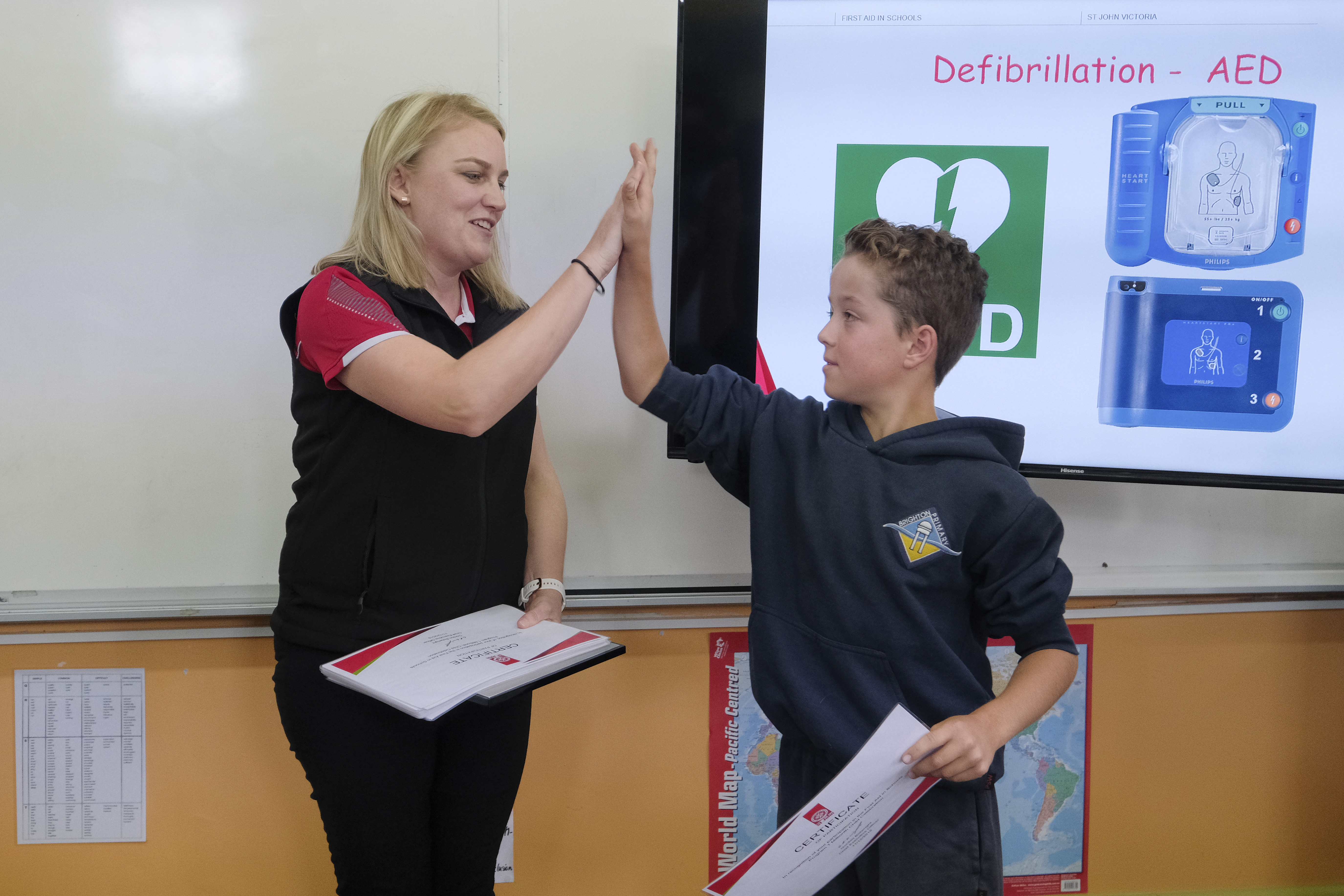 St John First Aid in Schools Program presenter hi-fiving student