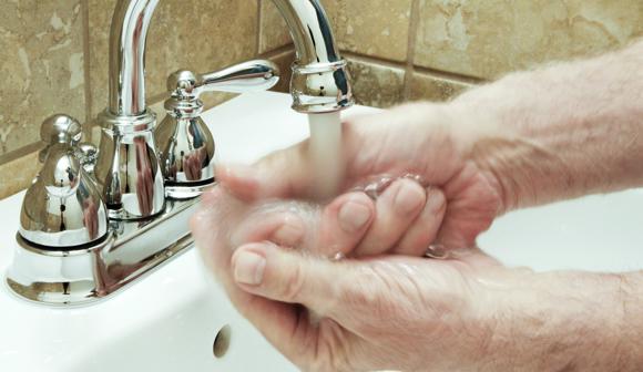 Person washing hands with soap