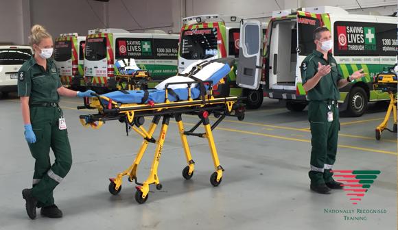 Two St John Ambulance Victoria Patient Transport clinical instructors delivering Patient Transport training in face masks