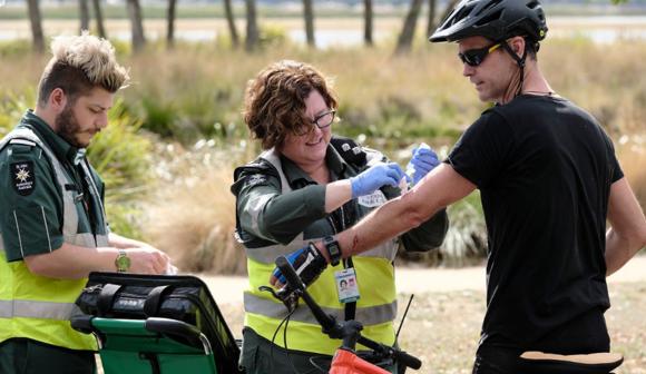 st john first aid at events volunteers bandaging a cyclist