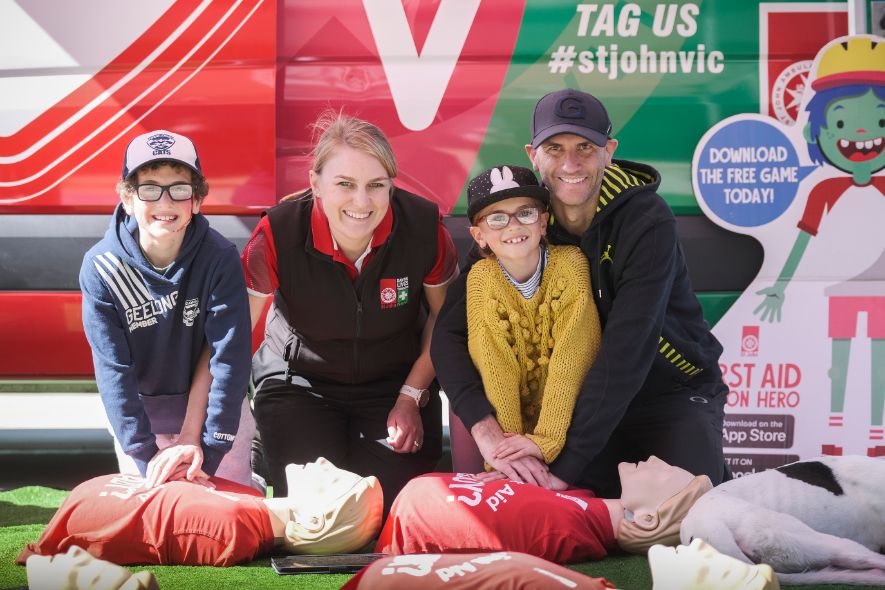 St John CPR lab with man and children learning CPR