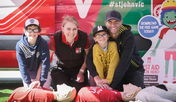 St John CPR lab with man and children learning CPR