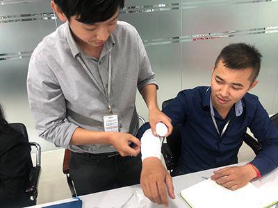 Cambodia students learning first aid bandaging