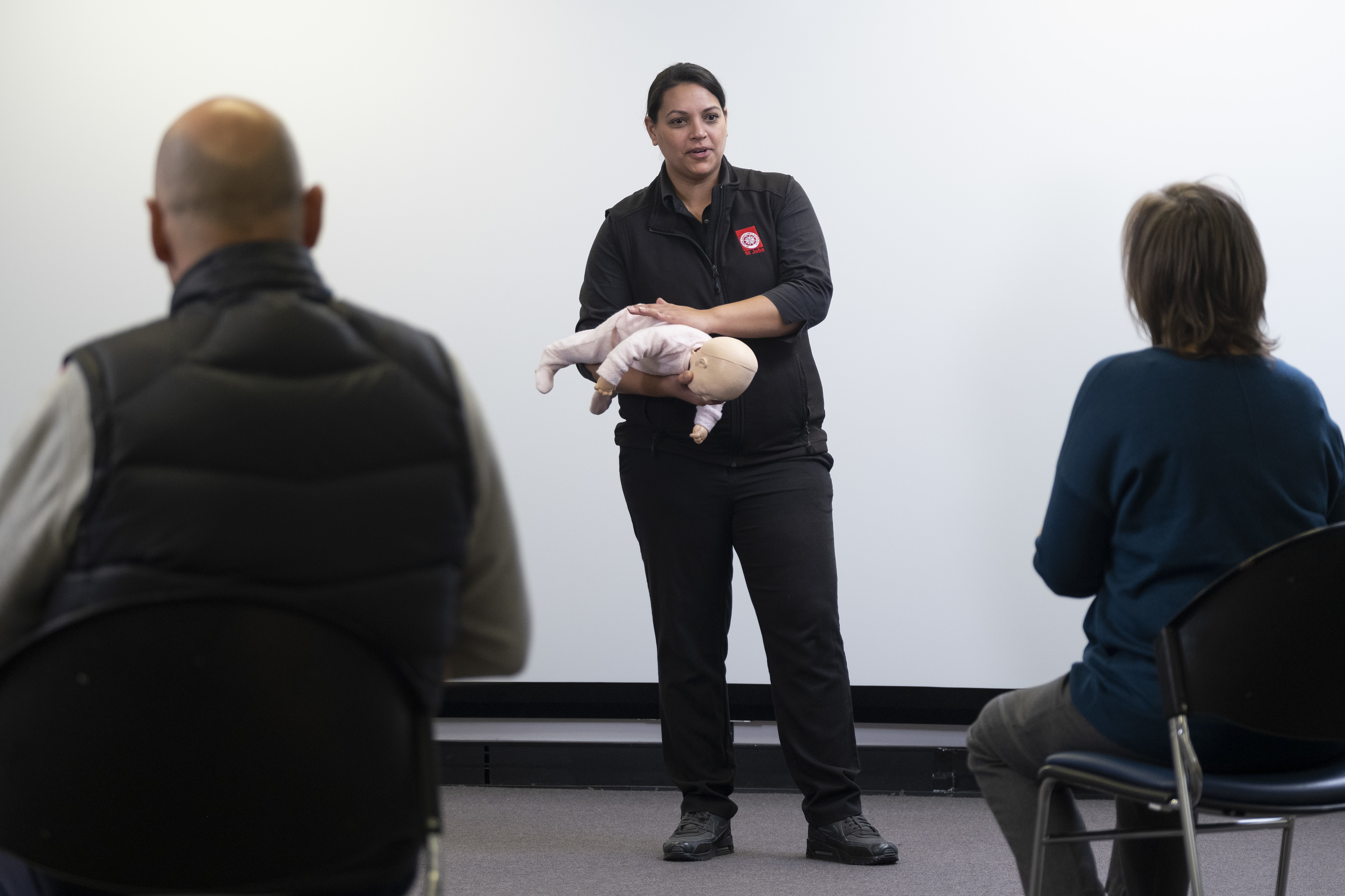 St John first aid training trainer with baby manikin 