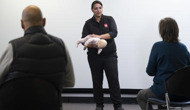 St John first aid training trainer with baby manikin 