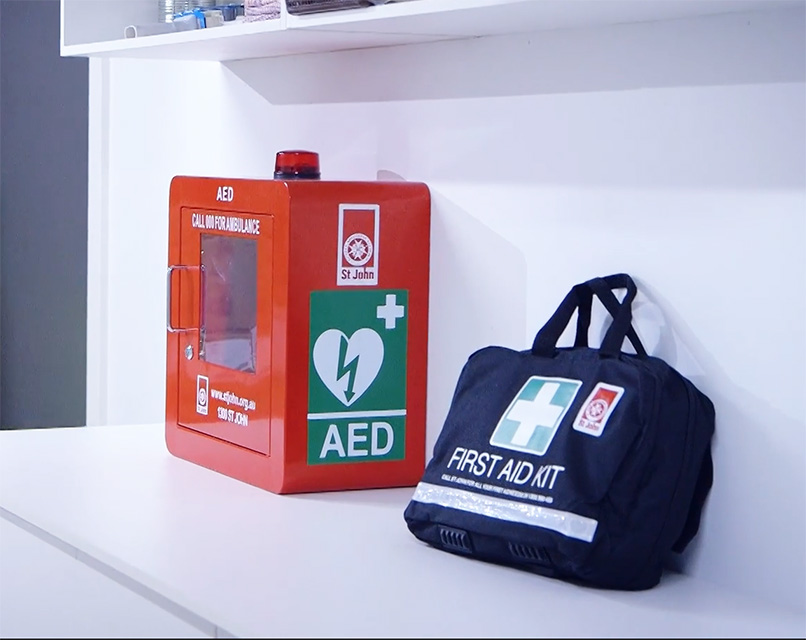 Defibrillator in red cabinet