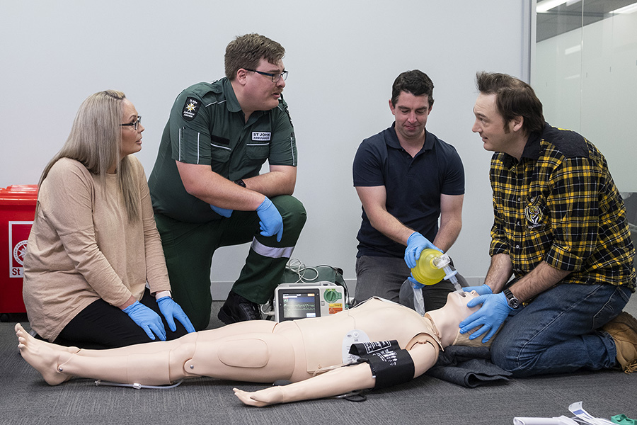 Diploma of emergency healthcare course - students performing life saving actions on mannikin