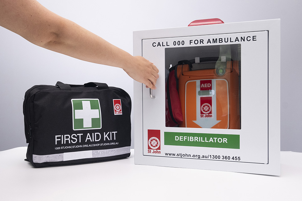 St John G5 Defibrillator in case next to a first aid kit