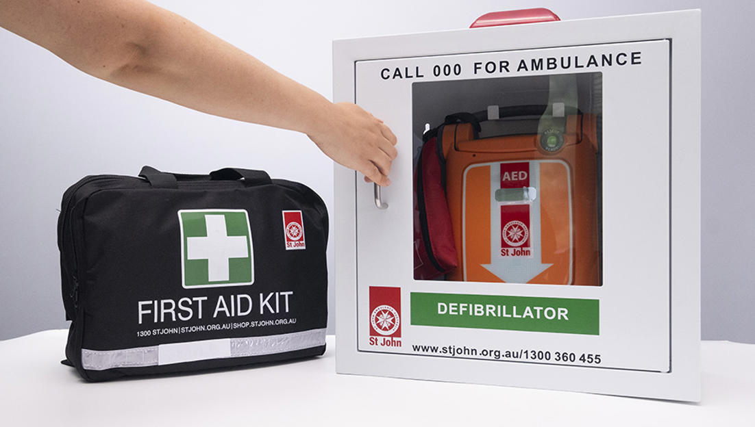 St John G5 Defibrillator in case next to a first aid kit