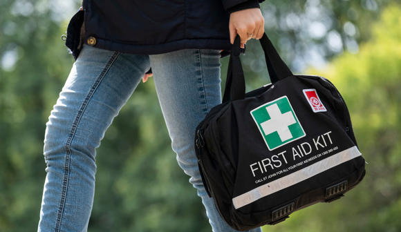 person carrying St John First Aid Kit
