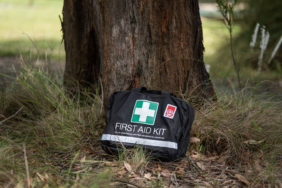 St John First Aid Kit next to tree
