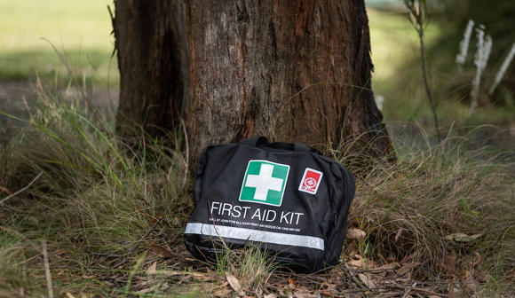St John First Aid Kit next to tree