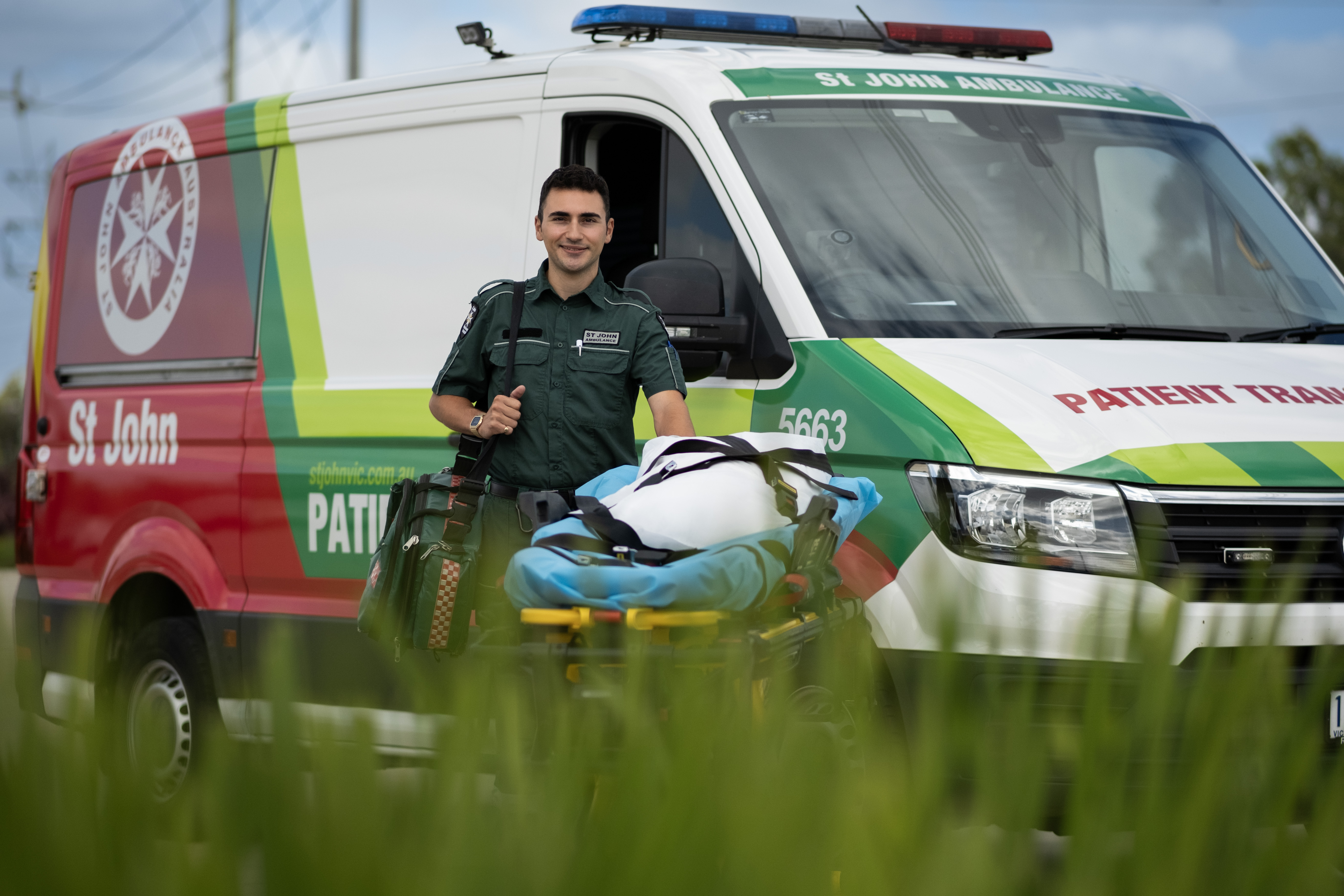 St John Ambulance Victoria Patient Transport Officer standing in front of patient transport vehicle