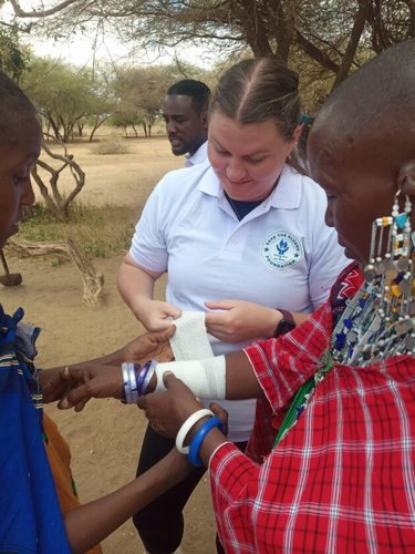 Caitlin bandaging a local in Tanzania