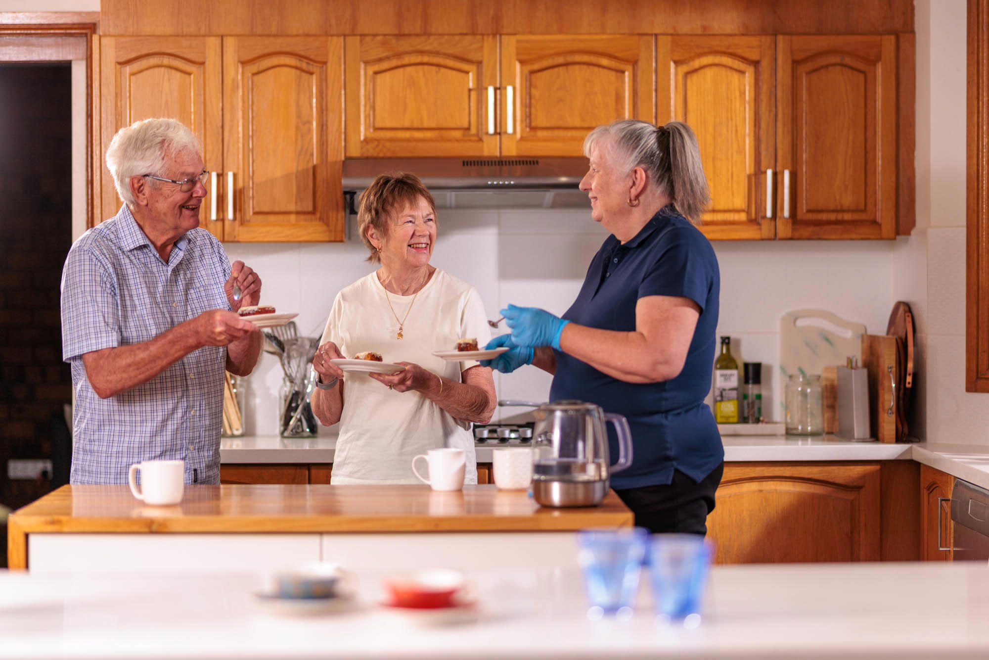 Carer with clients in the kitchen