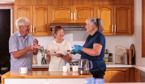 Carer with clients in the kitchen