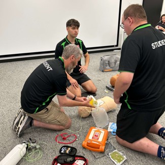 NEPT Students in class using oxygen on a manikin