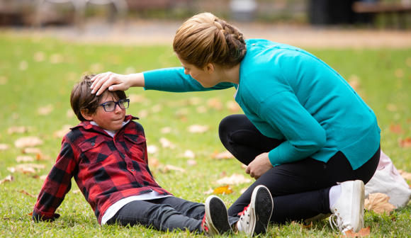 Boy suffering from Heat stroke with woman caring for him