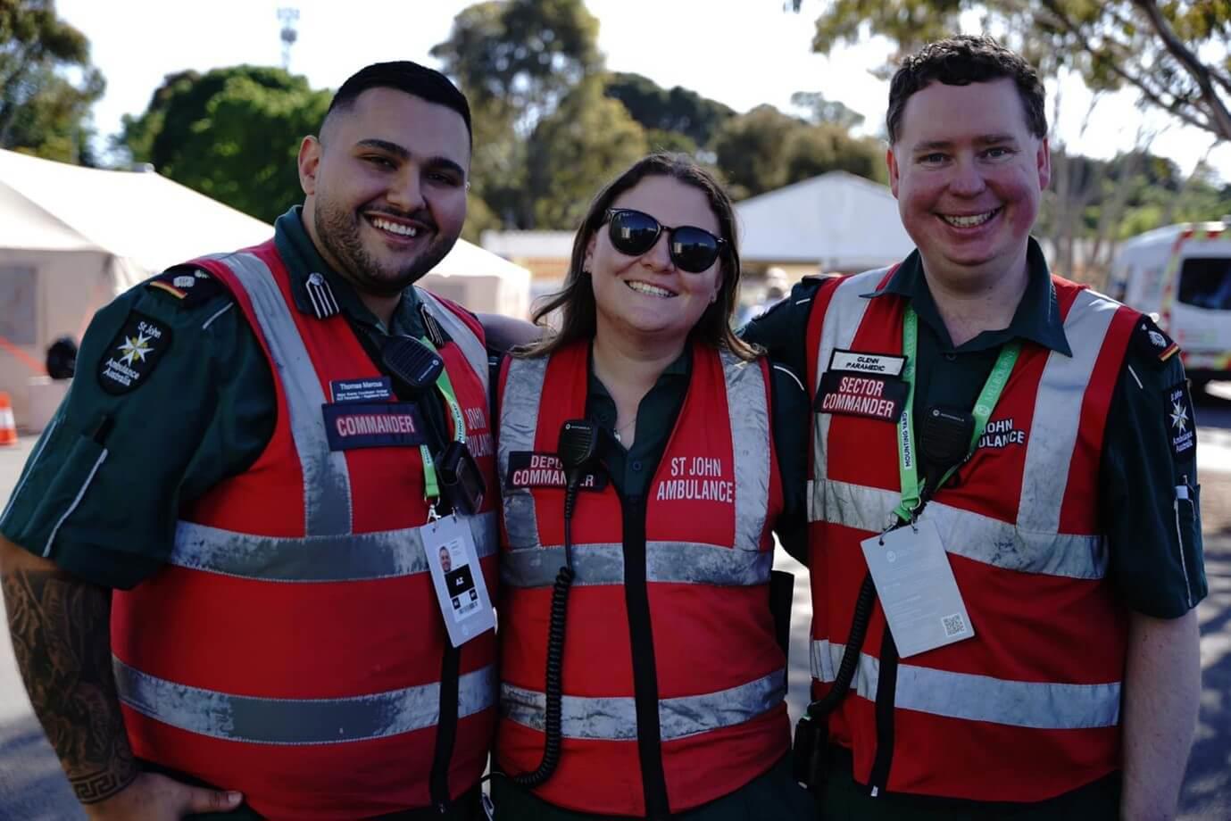 Caitlin at an event with two other volunteers