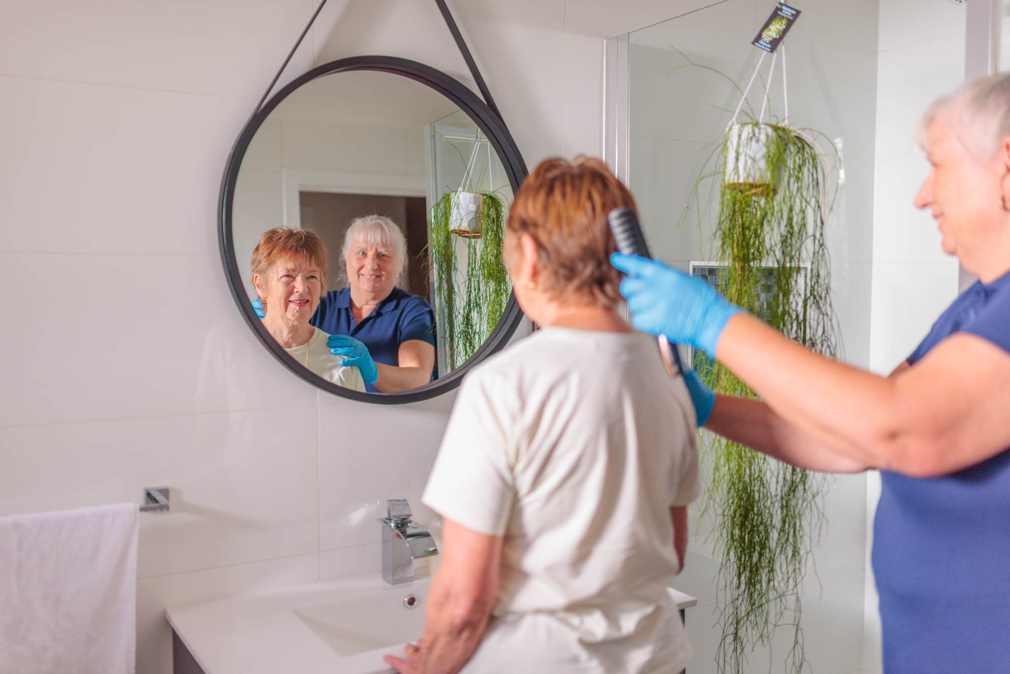 Seniors Community Care Carer with client in bathroom assisting with personal care duties